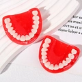 Macro shot of realistic resin teeth charms with red gums for DIY keychain accessories - Red