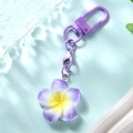 Detail of gradient purple plumeria flower keychain with matching lacquered metal hardware - Purple