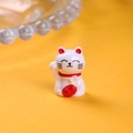 Close-up of white resin lucky cat figurine with red money bag and golden bell detail - Single Piece / White (Right Hand Raised)