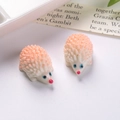 Detailed view of two cute resin hedgehog figurines for DIY fairy garden ornaments - Pink