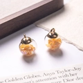 Pair of glass ball charms with orange heart sequins and light gold metal caps - Yellow