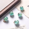 Five mint green heart sequin filled glass ball pendants with golden metal loops - Emerald