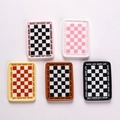 Detailed macro view of five miniature resin checkered plates with Good Life text borders - Rectangle Mixed Colors