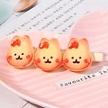 Cute Japanese style hair clip featuring three orange resin bunnies on a metal duckbill base - Cranberry Rabbit Cookie