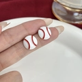 Macro shot of baseball enamel stud earrings with red stitching details on white base - Classic Baseball Studs