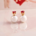 Elegant gold crown stud earrings featuring a red cubic zirconia and a white round pearl - Red