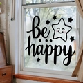 Dettaglio dell'adesivo murale 'be happy' con stella sorridente su vetro finestra - Stile Be happy (AM22001)