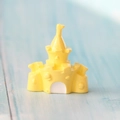 Macro view of a miniature yellow resin castle accessory for DIY jewelry and crafts - Castle Yellow