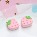 Close-up of strawberry resin cookie charms for DIY crafts and hair accessories - Pink / Large