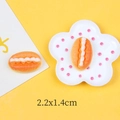 Detailed macro view of 22mm miniature resin bread charms with white cream texture - Cream Bread