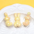 Macro view of three yellow iridescent bunny beads in a white porcelain dish for DIY - 3mm Hole / Yellow