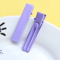 Detail of purple alligator hair clips with smooth finish and reinforced groove design - Matte Purple