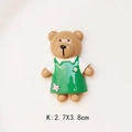 Detailed view of 2.7x3.8cm cartoon brown resin bear wearing a green floral dress - White Shirt Green Skirt