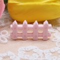 Detailed view of pink miniature resin fence for DIY dollhouse and micro landscape decor - 1.6x3.1cm / Light Pink