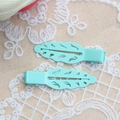 Detail of two mint green leaf hair clips with hollow design on lace background - Hollow Leaf Style (MG-S7050) / Emerald