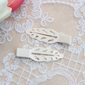Close-up of cream leaf-shaped metal hair clips with hollow design on lace background - Hollow Leaf Style (MG-S7050) / Off White