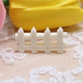 Close-up of a white miniature resin picket fence for DIY dollhouse and micro-landscapes - 1.6x3.1cm / White
