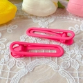 Detail view of pink matte hair clips with minimalist hollow design on lace background - Matte Hot Pink