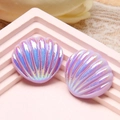 Macro view of light purple iridescent shell resin accessories with pearl finish on lace - Purple