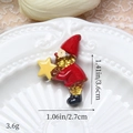 Vue macro d'un gnome de Noël en résine pailletée, taille 3,6x2,7 cm et un poids de 3,6 g - Gnome Doré Avec Étoile