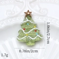 Detailed view of a green resin Christmas tree charm with colorful ornaments and gold star - Wavy Christmas Tree Light Green
