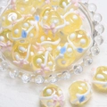 Macro detail of handmade yellow glass beads with glitter and floral 3D patterns - 18mm / Yellow Bead + Blue Leaf + Pink Bow