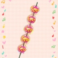 Close-up of clear acrylic star beads with pink core and yellow Star lettering details - Rose Red With Star