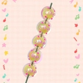 Macro detail of acrylic Christmas beads with pink LIKE text and colorful dots - Yellow With LIKE Text