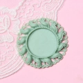 Detail of 2.5cm mint green round cameo base with vintage embossed resin floral patterns - Baby Blue