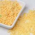 Macro detail of bright yellow simulated chocolate crumble and crumbs for DIY crafts - 10g Per Pack / Mango Yellow