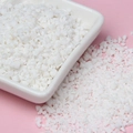 Macro shot of white sprinkles and clay crumbs for DIY crafts on a pink backdrop - 10g Per Pack / Coconut White