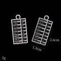 Vintage silver alloy abacus pendant for DIY jewelry, size 2.6cm by 1.3cm on black background - Abacus