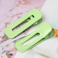 Detail of two light green matte duckbill hair clips with non-slip hollow design - Grass Green