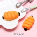 Gedetailleerde macro-opname van een oranje hars rups miniatuur van 1,2x2,2 cm - Hotdog