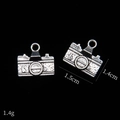 Macro detail of vintage camera alloy pendants in antique silver finish for DIY jewelry - Camera Style A