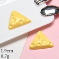 Macro detail of a 1.9cm resin miniature cheese wedge model for DIY dollhouse decoration - Triangle Cheese