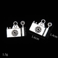 Detailed macro view of vintage silver camera charms with 1.6cm x 1.4cm dimensions - Camera Style B