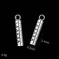 Macro view of ruler-shaped antique silver alloy pendant with dimensions 2.4cm by 0.5cm - Ruler