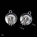 Macro view of vintage silver alloy mini cutlery pendant with 1.5cm-2cm dimensions - Tableware