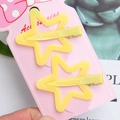 Set di due fermagli per capelli a stella gialla opaca su cartoncino decorativo - Giallo