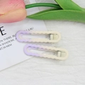 Detail of purple gradient wavy hair clips on a soft textured background with floral decor - Light Purple