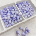 Detailed macro view of 8mm white and purple ink-style round glass beads for DIY jewelry - 100pcs Pack / Ink Wash - Oriental Purple