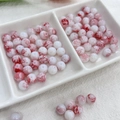 Close-up of 8mm red and white ink-wash style glass beads with unique marble texture - 100pcs Pack / Agate Red