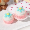 Macro view of miniature resin cupcakes with pink base and blue flowers for DIY crafts - Pink Bottom Blue Flower