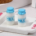 Close-up of two miniature resin milk bottles with milk labels for dollhouse decor - 3D / Blue
