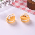 Macro view of mini yellow macaron charms with bow detail for DIY jewelry and crafts - S / Yellow
