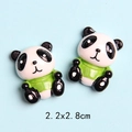 Macro detail of resin panda charm with green shirt for DIY crafts and phone case decor - Panda in Green Clothes