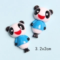 Macro detail of cartoon resin panda charms with 3.2x2cm dimensions for DIY crafts - Blue Clothes