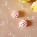 Vue macro de deux breloques en résine rose en forme de coquille pour artisanat DIY - Rose Clair