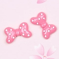 Macro detail of large pink resin bow charms with white polka dots for DIY hair accessories - Polka Dot Bow / Deep Pink